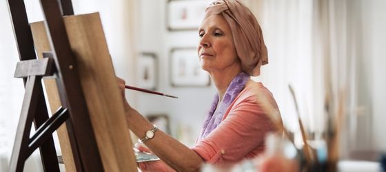 A woman painting on an easel