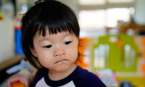 Close up of a toddler looking away to left side in a contemplative mood