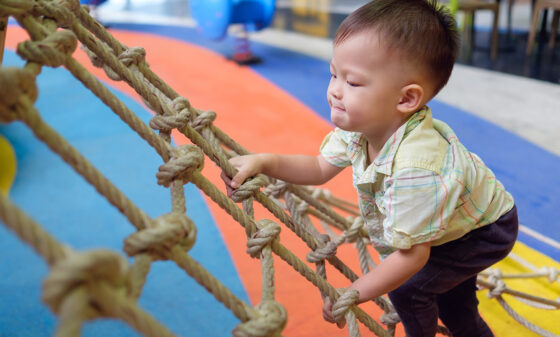 Child climbing on net